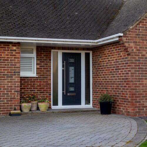 Brick,Built,Bungalow,With,A,Dark,Blue,Contemporary,Front,Door