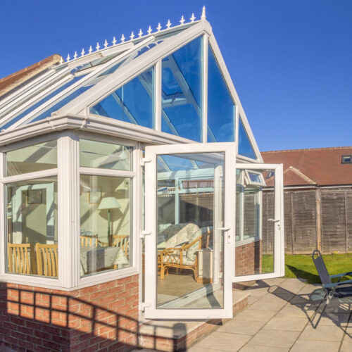 Conservatory,Tables,Chairs,Plants,Room,In,House,Next,To,Garden