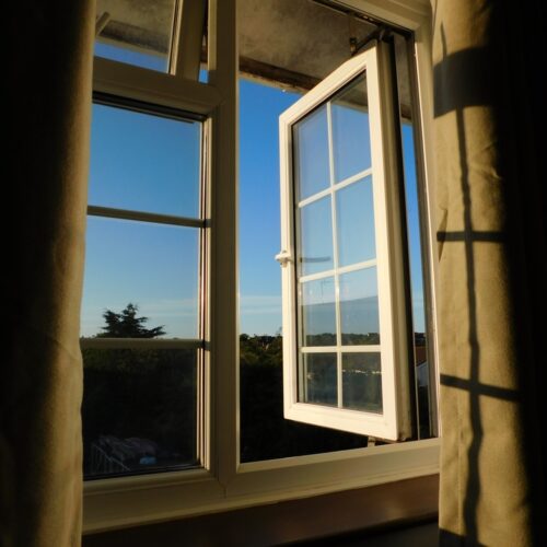 Open,Bedroom,Window,With,Sunrise,Sunlight,Casting,Shadows,On,The